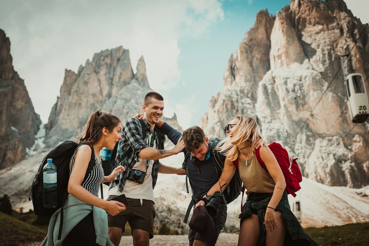 Group of friends celebrating on a scenic hilltop overlooking the sea